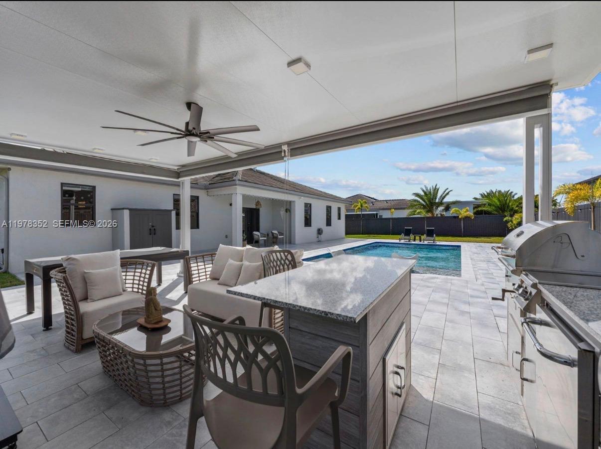 13351 Southwest 190th Street Miami, FL 33177 - Photo 32 of 45 a dining room with furniture and a floor to ceiling window