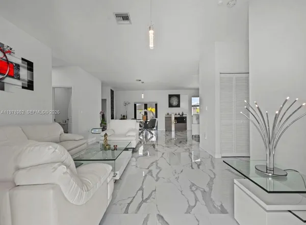 a dining room with furniture window and wooden floor