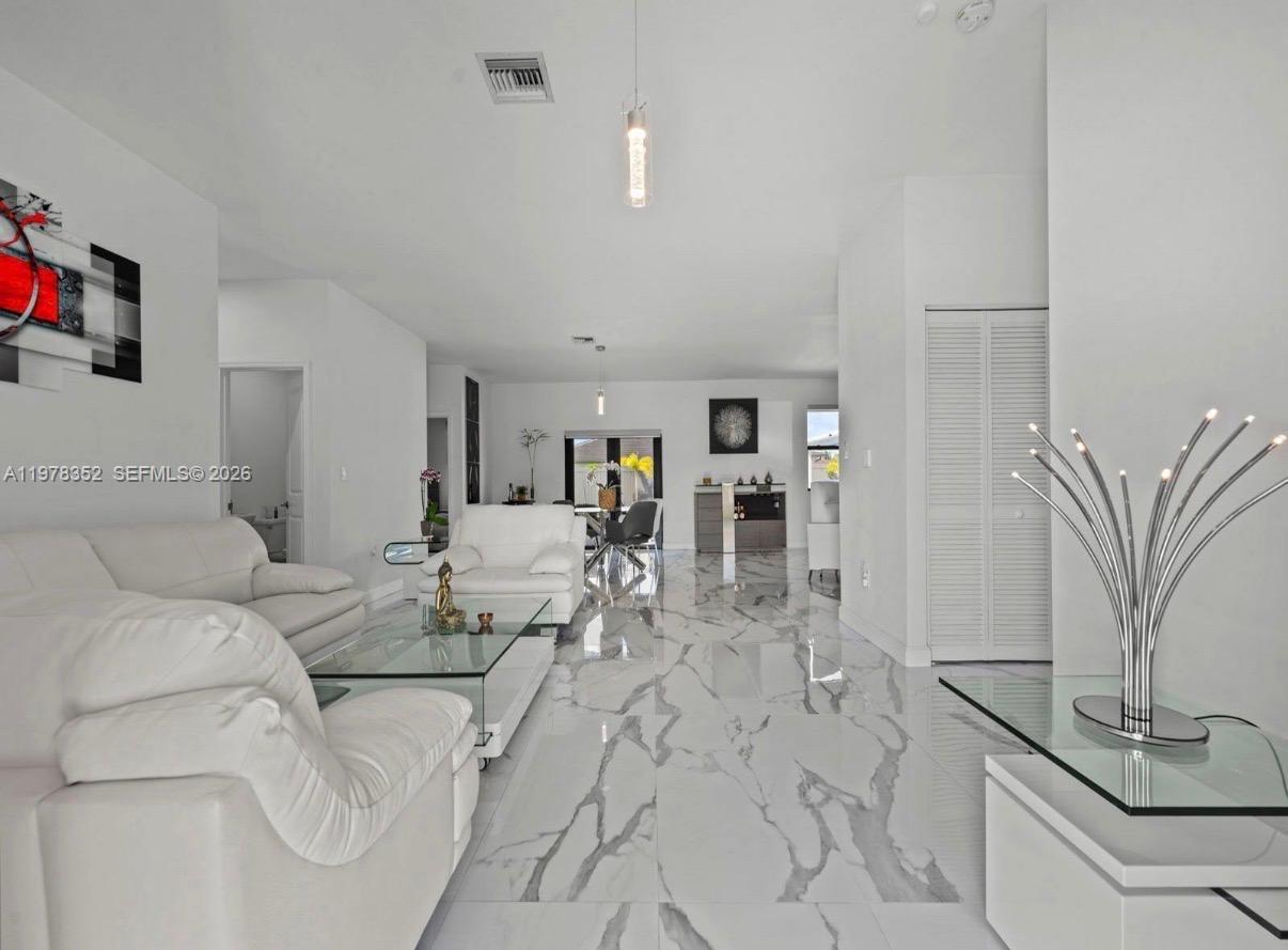 13351 Southwest 190th Street Miami, FL 33177 - Photo 4 of 45 a living room with furniture and a flat screen tv