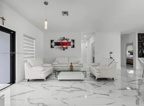 a living room with furniture and a flat screen tv