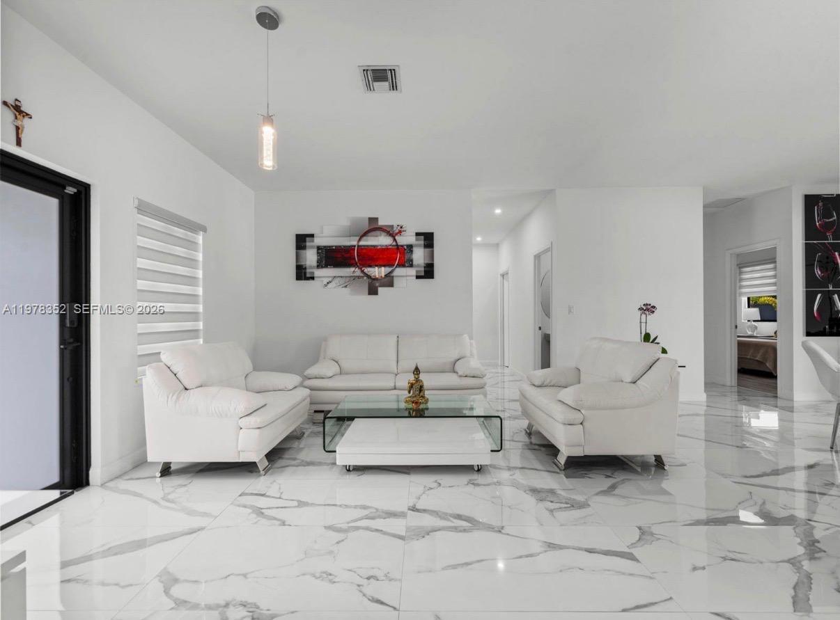 13351 Southwest 190th Street Miami, FL 33177 - Photo 5 of 45 a living room with furniture and a flat screen tv
