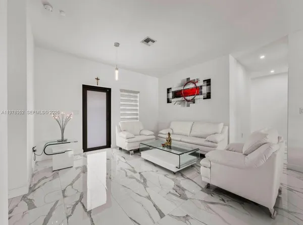 a kitchen with stainless steel appliances kitchen island granite countertop a refrigerator and a stove top oven