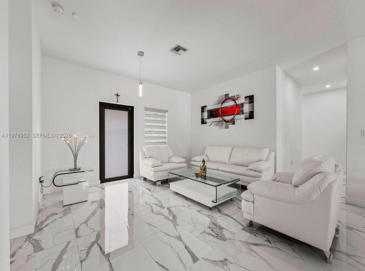 13351 Southwest 190th Street Miami, FL 33177 - Photo 6 of 45 a living room with furniture and white walls