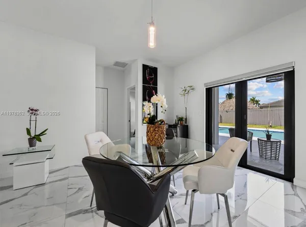 a living room with furniture and a dining table with kitchen view