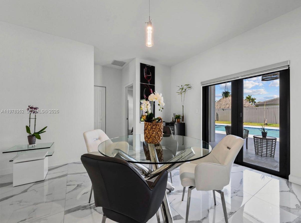 13351 Southwest 190th Street Miami, FL 33177 - Photo 7 of 45 a dining room with furniture window and wooden floor