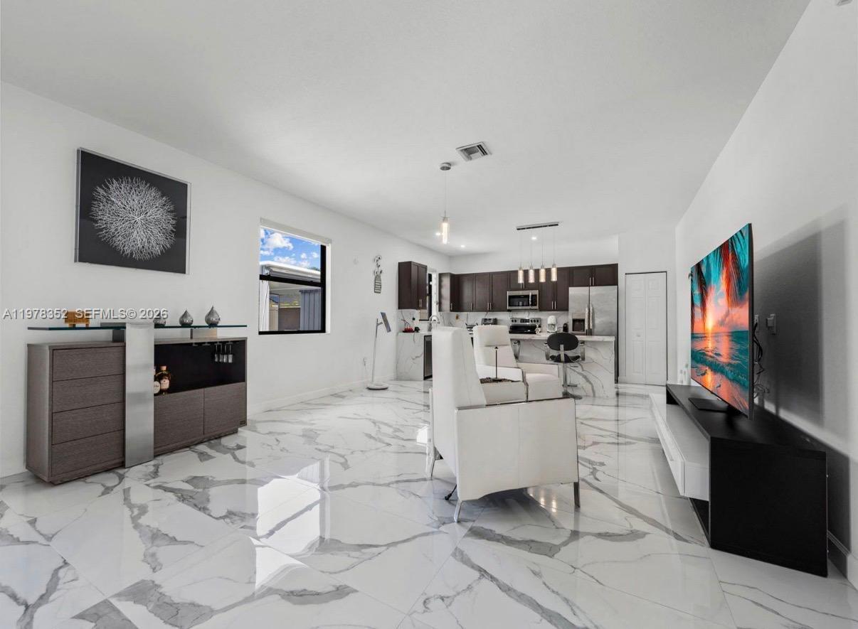 13351 Southwest 190th Street Miami, FL 33177 - Photo 8 of 45 a living room with furniture and a flat screen tv