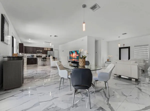 a kitchen with a sink counter top space appliances and cabinets