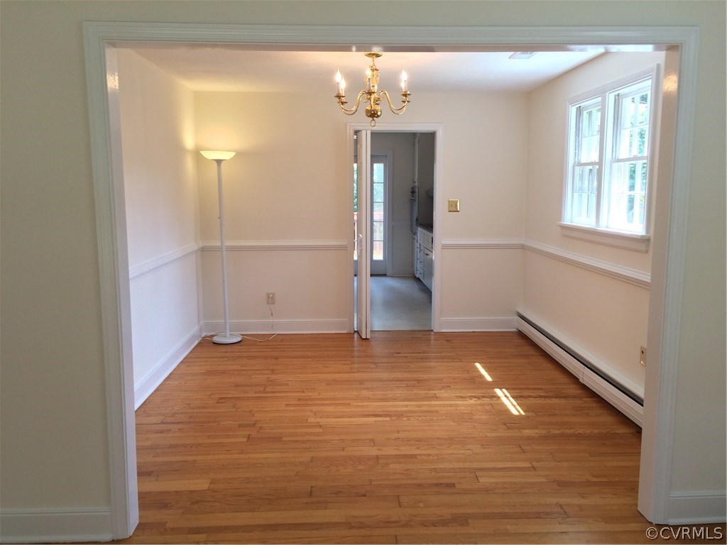 4035 Collingbourne Road Richmond, VA 23235 - Photo 11 of 30 a view of an empty room with wooden floor and a window