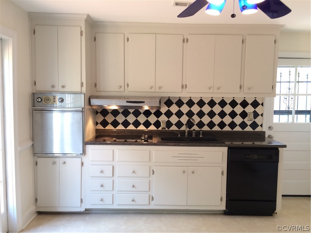 4035 Collingbourne Road Richmond, VA 23235 - Photo 13 of 30 a kitchen with white cabinets and black appliances