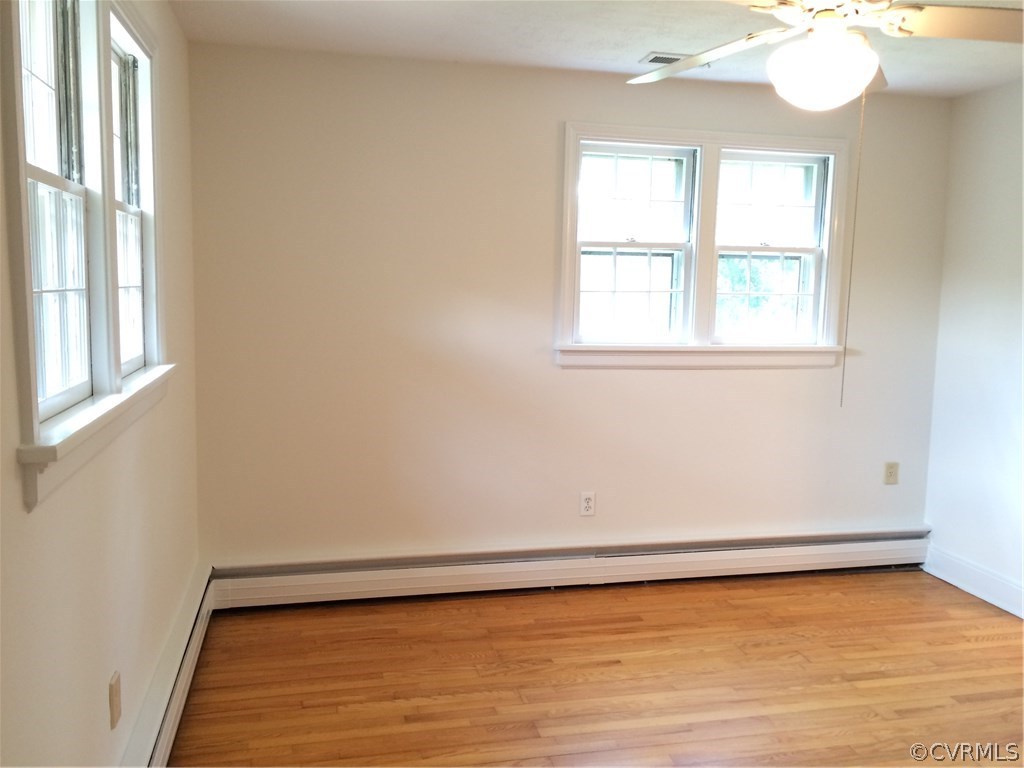 4035 Collingbourne Road Richmond, VA 23235 - Photo 17 of 30 a view of an empty room with wooden floor and a window