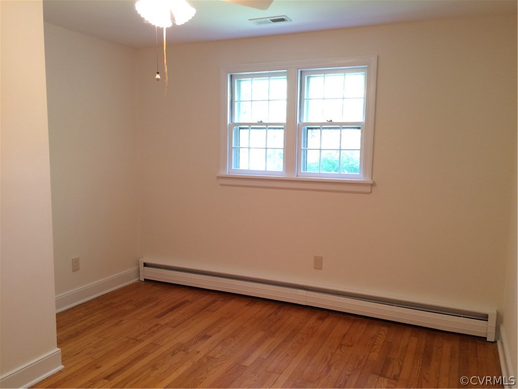 4035 Collingbourne Road Richmond, VA 23235 - Photo 21 of 30 an empty room with wooden floor and windows