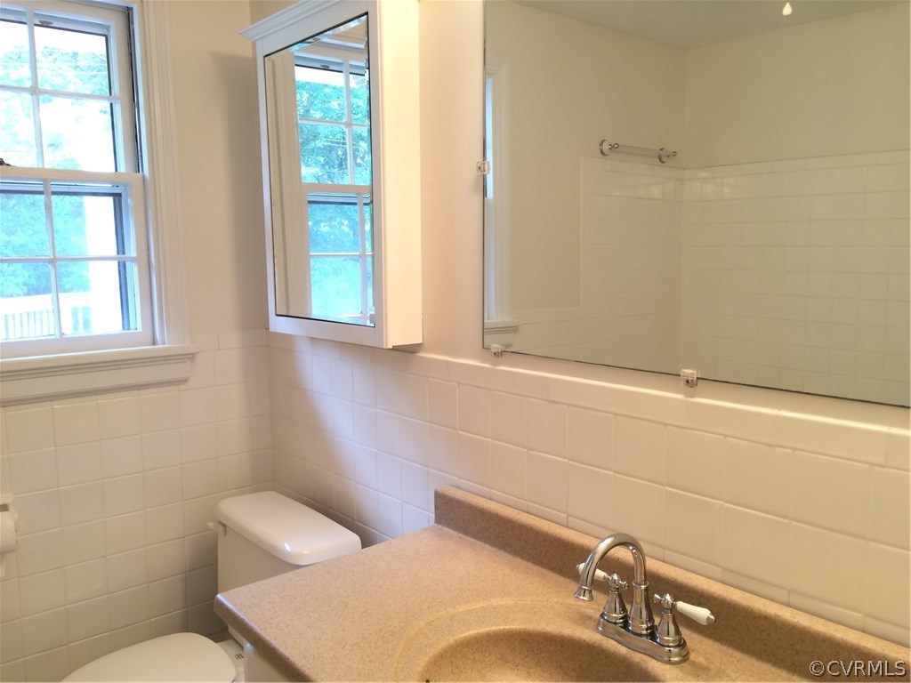 4035 Collingbourne Road Richmond, VA 23235 - Photo 23 of 30 a bathroom with a toilet sink and mirror