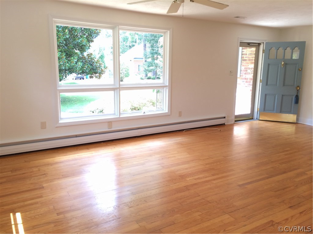 4035 Collingbourne Road Richmond, VA 23235 - Photo 6 of 30 an empty room with wooden floor and windows