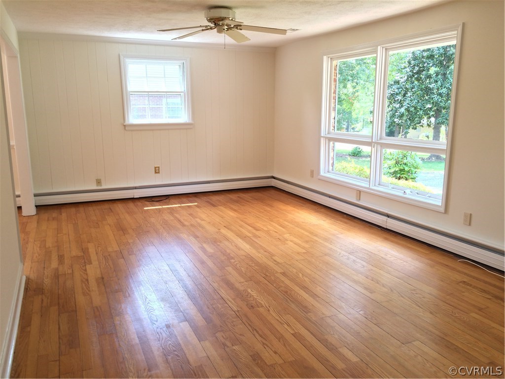 4035 Collingbourne Road Richmond, VA 23235 - Photo 7 of 30 an empty room with wooden floor and windows