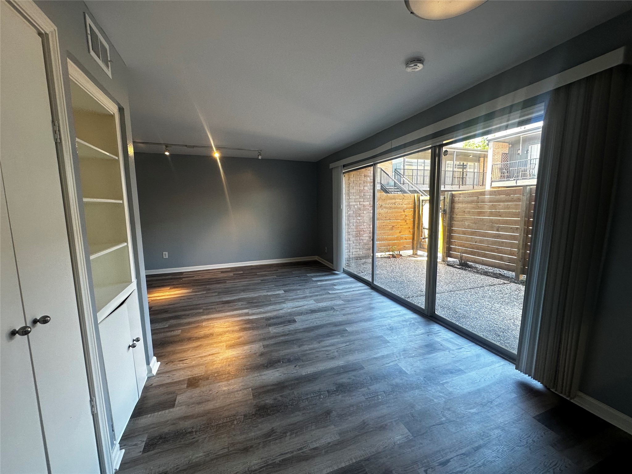 3262 Branard Street, Unit 17 Houston, TX 77098 - Photo 2 of 8 an empty room with wooden floor and windows
