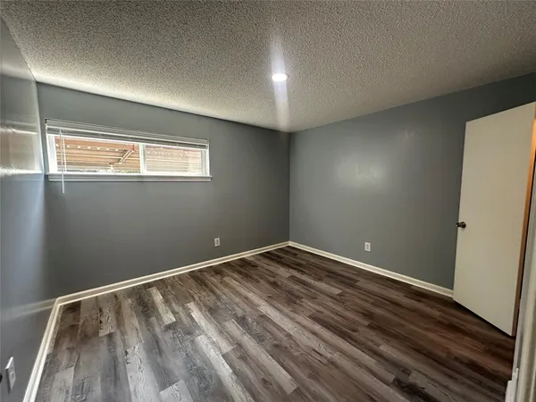 a view of room with window and hardwood floor