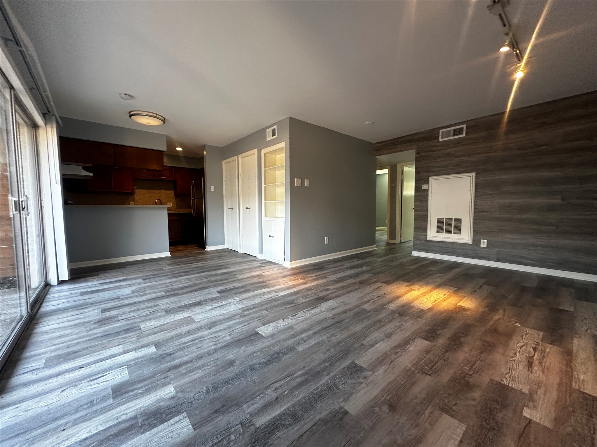 3262 Branard Street, Unit 17 Houston, TX 77098 - Photo 5 of 8 a view of empty room with wooden floor and fan