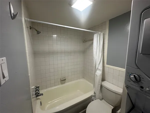 a bathroom with a toilet and a bathtub
