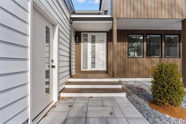 a view of a kitchen with a refrigerator and wooden floor