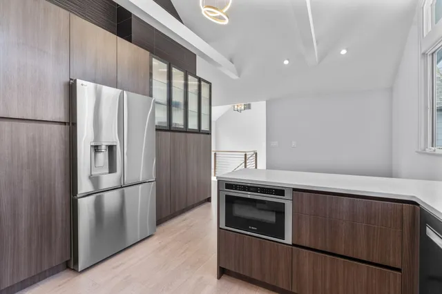 a bedroom with a bed and a table in it with wooden floor