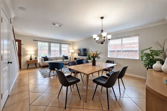a view of a dining room with furniture and a chandelier