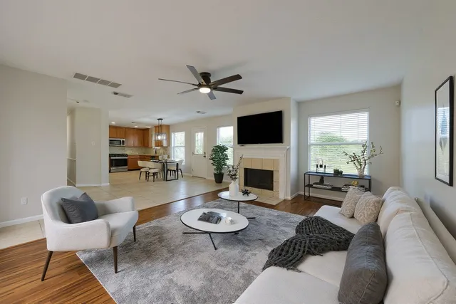 a bedroom with a large bed a chandelier and windows