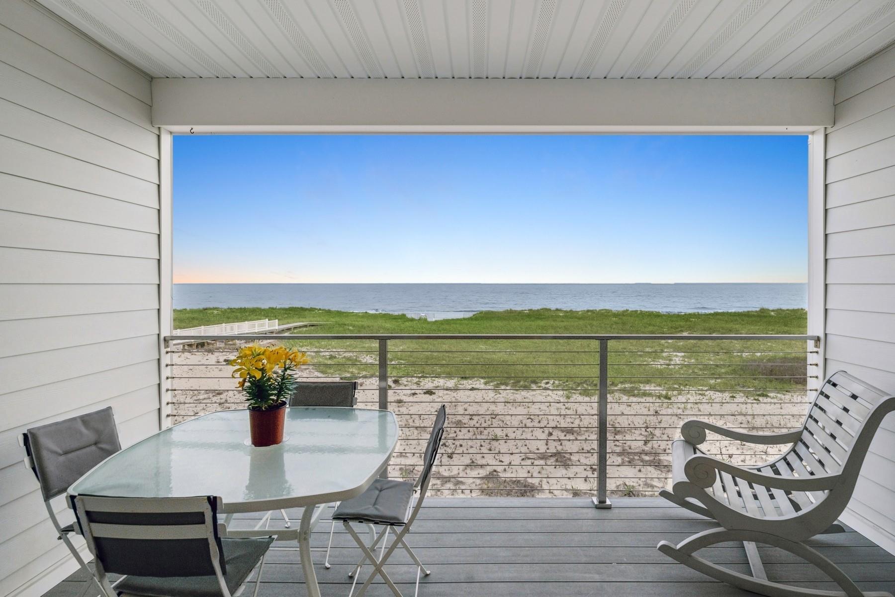 Private covered deck with unobstructed beach and ocean views.