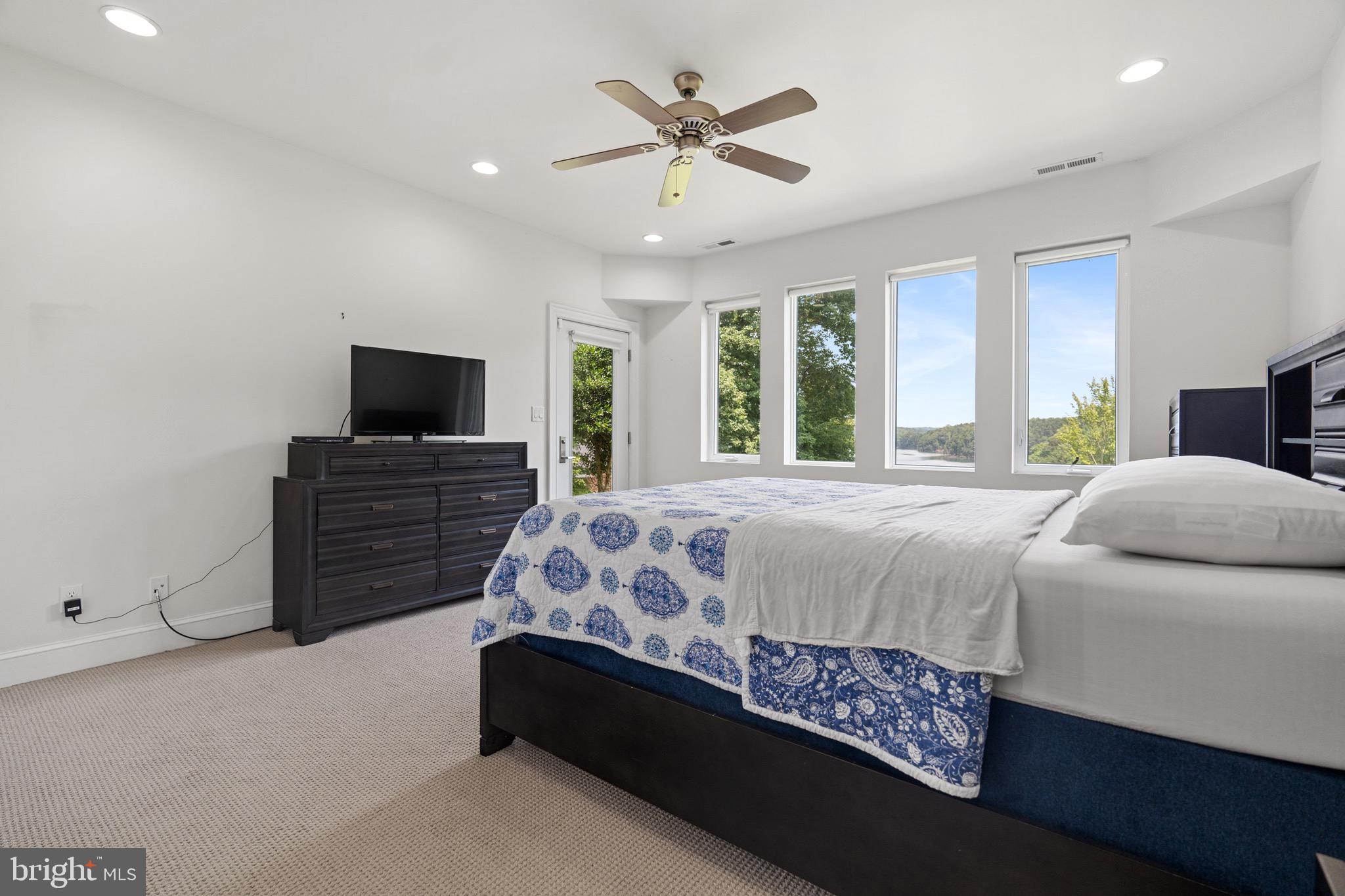 174 Virginia Key Trail Union Hall, VA 24176 - Photo 29 of 85 a bed sitting in a spacious bedroom next to a window and a flat screen tv