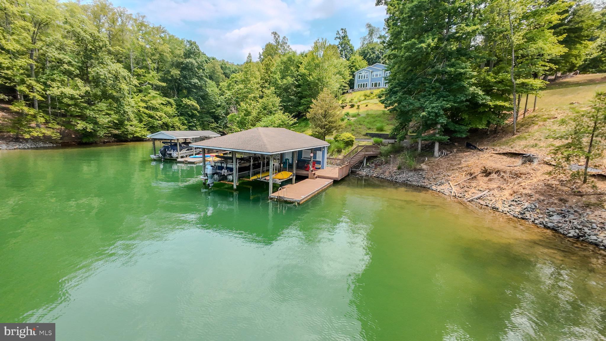 174 Virginia Key Trail Union Hall, VA 24176 - Photo 71 of 85 a view of a lake with a table and chairs under an umbrella