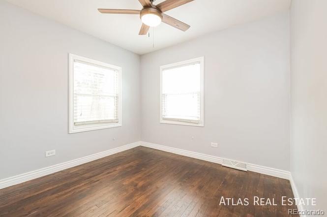 661 Stuart Street Denver, CO 80204 - Photo 12 of 18 an empty room with wooden floor and windows