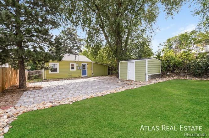 661 Stuart Street Denver, CO 80204 - Photo 18 of 18 a view of a yard with a house and a large tree