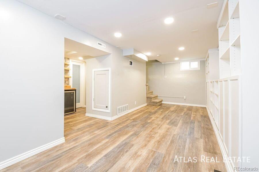 661 Stuart Street Denver, CO 80204 - Photo 3 of 18 a view of a hallway with wooden floor