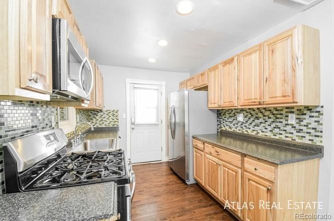 661 Stuart Street Denver, CO 80204 - Photo 9 of 18 a kitchen with stainless steel appliances granite countertop a stove and a refrigerator