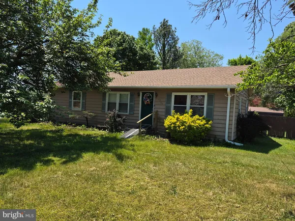 a view of a house with backyard sitting area and garden
