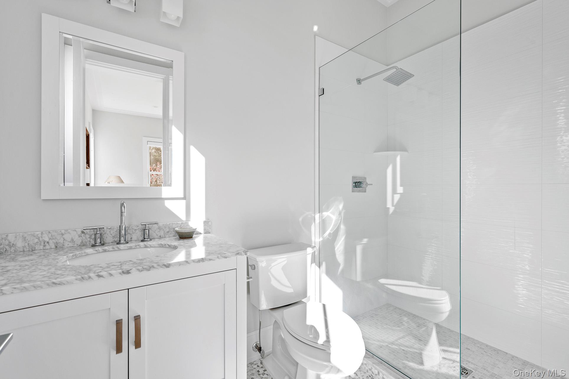 41 Arbutus Road Quogue, NY 11959 - Photo 16 of 35 a bathroom with a granite countertop sink a toilet and a mirror