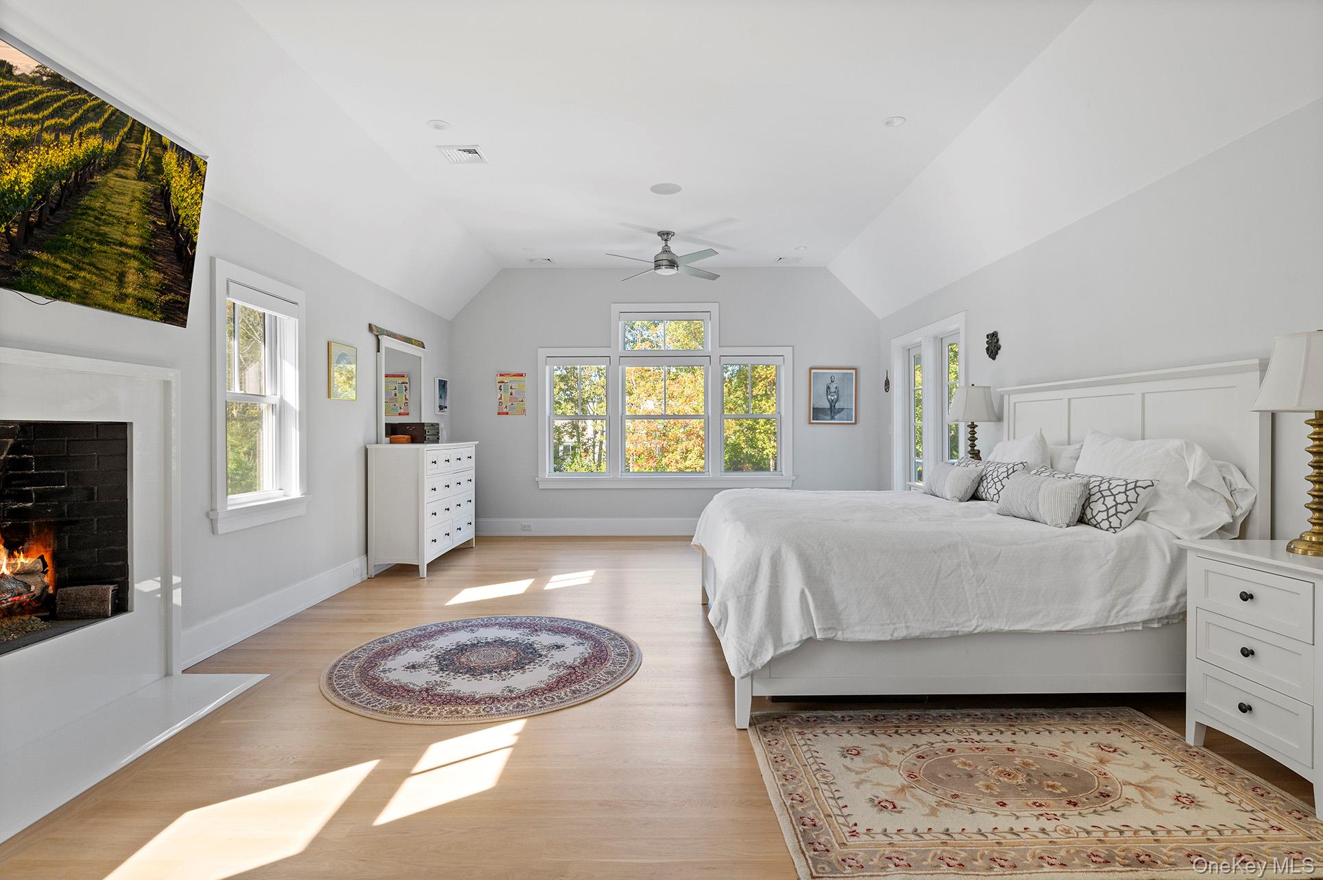 41 Arbutus Road Quogue, NY 11959 - Photo 20 of 35 a bedroom with a bed a fireplace and a window