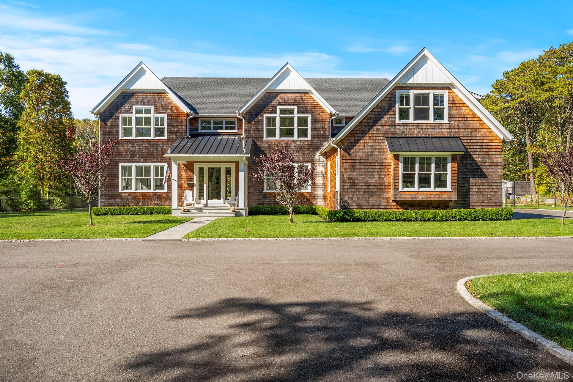 41 Arbutus Road Quogue, NY 11959 - Photo 2 of 35 a front view of a house with a yard