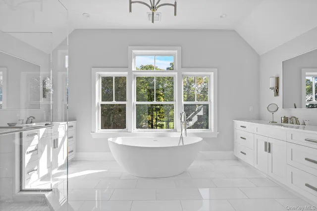 a large spacious bathroom with a large tub and shower