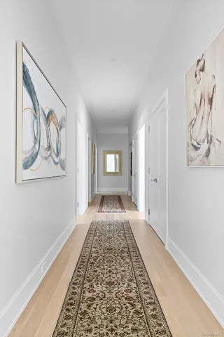 a view of a hallway with wooden floor