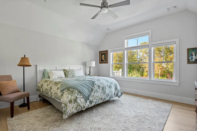a bedroom with a bed couch and window