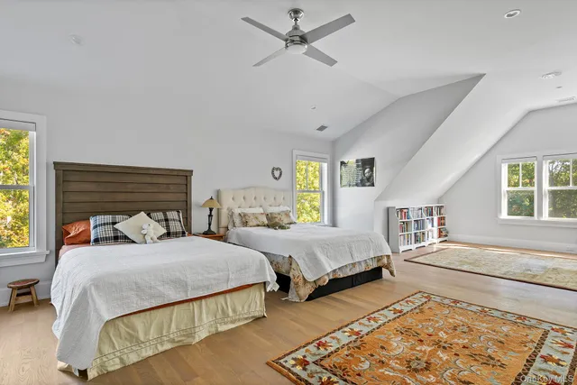 a bedroom with two beds and a window