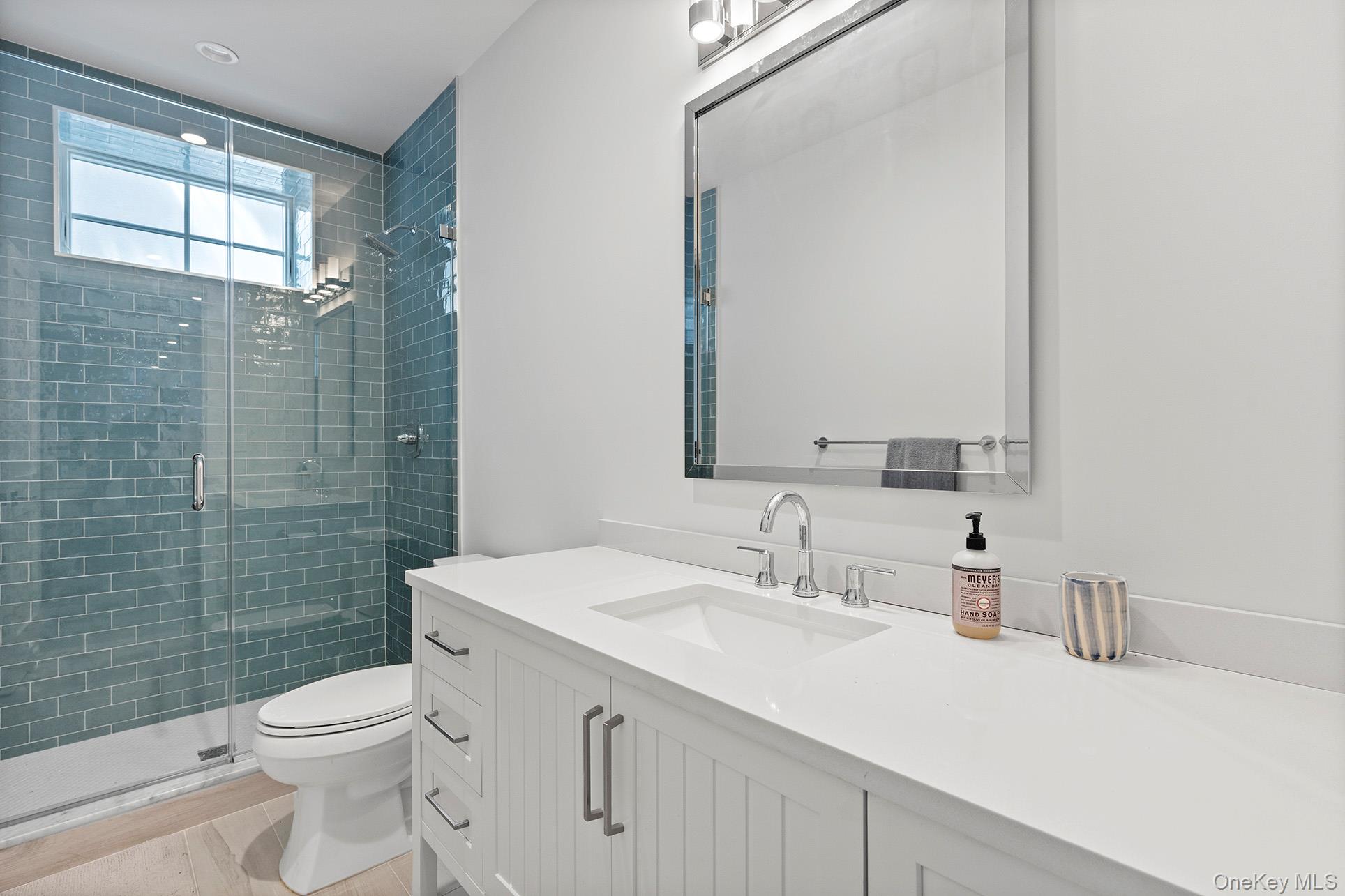 41 Arbutus Road Quogue, NY 11959 - Photo 31 of 35 a bathroom with a sink a toilet and shower