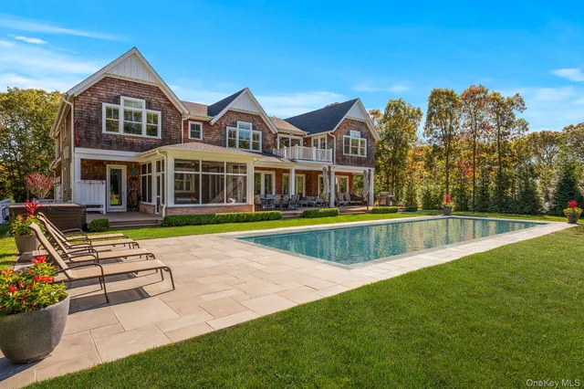 a view of an house with swimming pool and porch