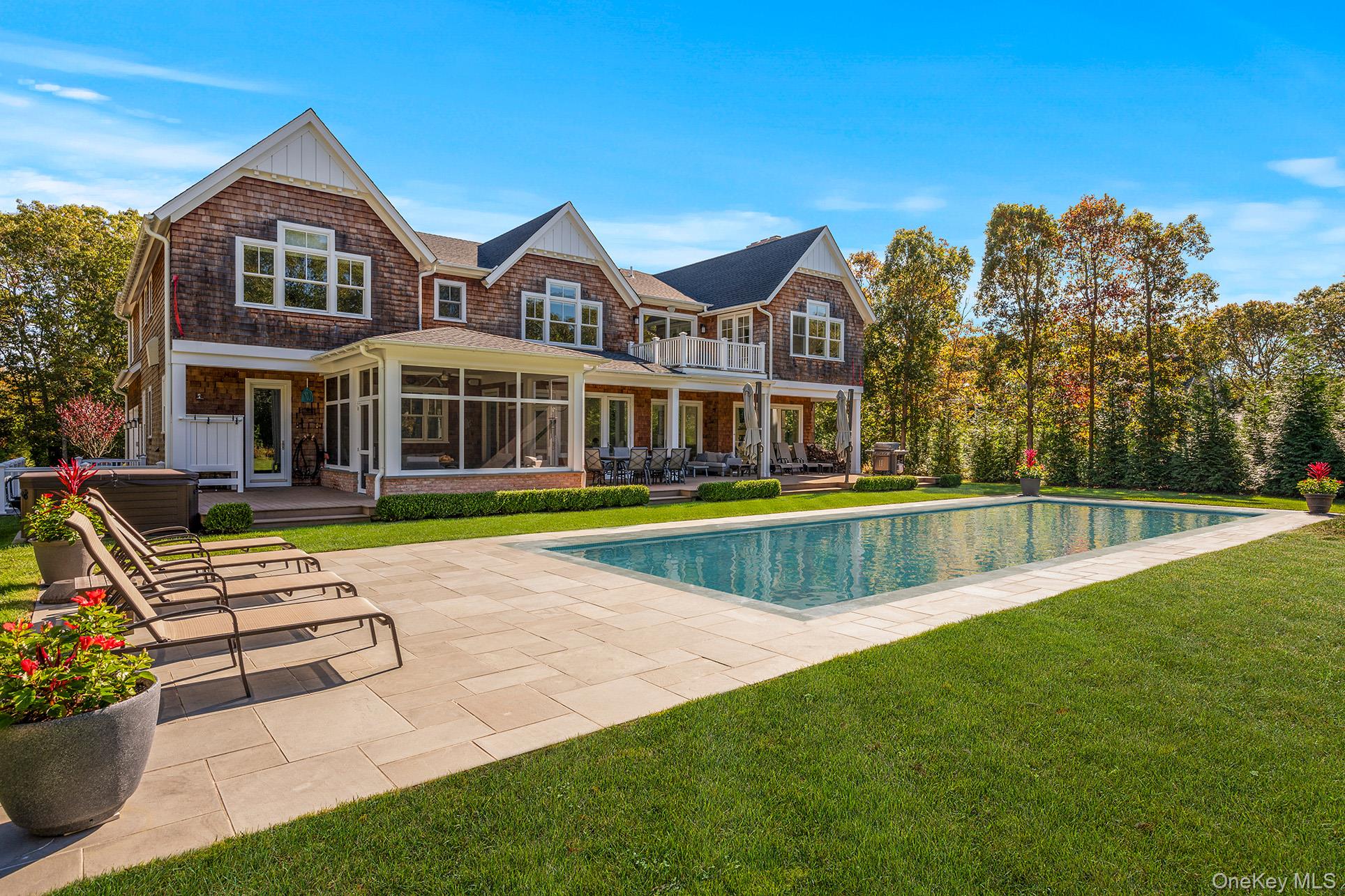 41 Arbutus Road Quogue, NY 11959 - Photo 5 of 35 a view of an house with swimming pool and porch