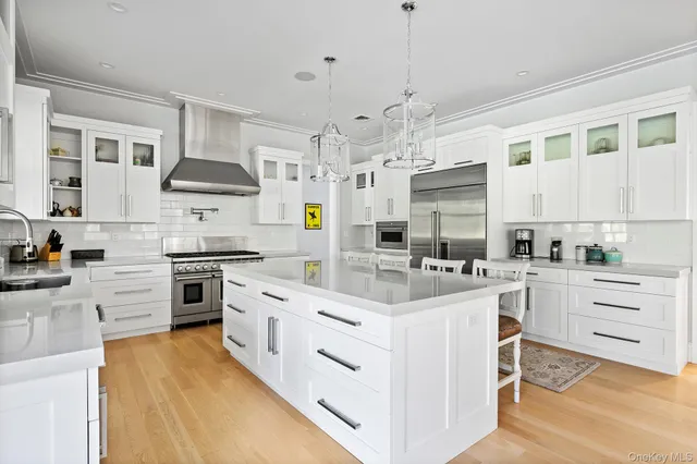 a kitchen with kitchen island granite countertop appliances cabinets and a sink
