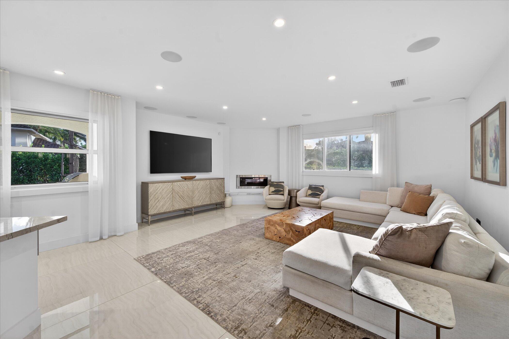 3872 Northwest 53rd Street Boca Raton, FL 33496 - Photo 15 of 43 a living room with furniture and a flat screen tv