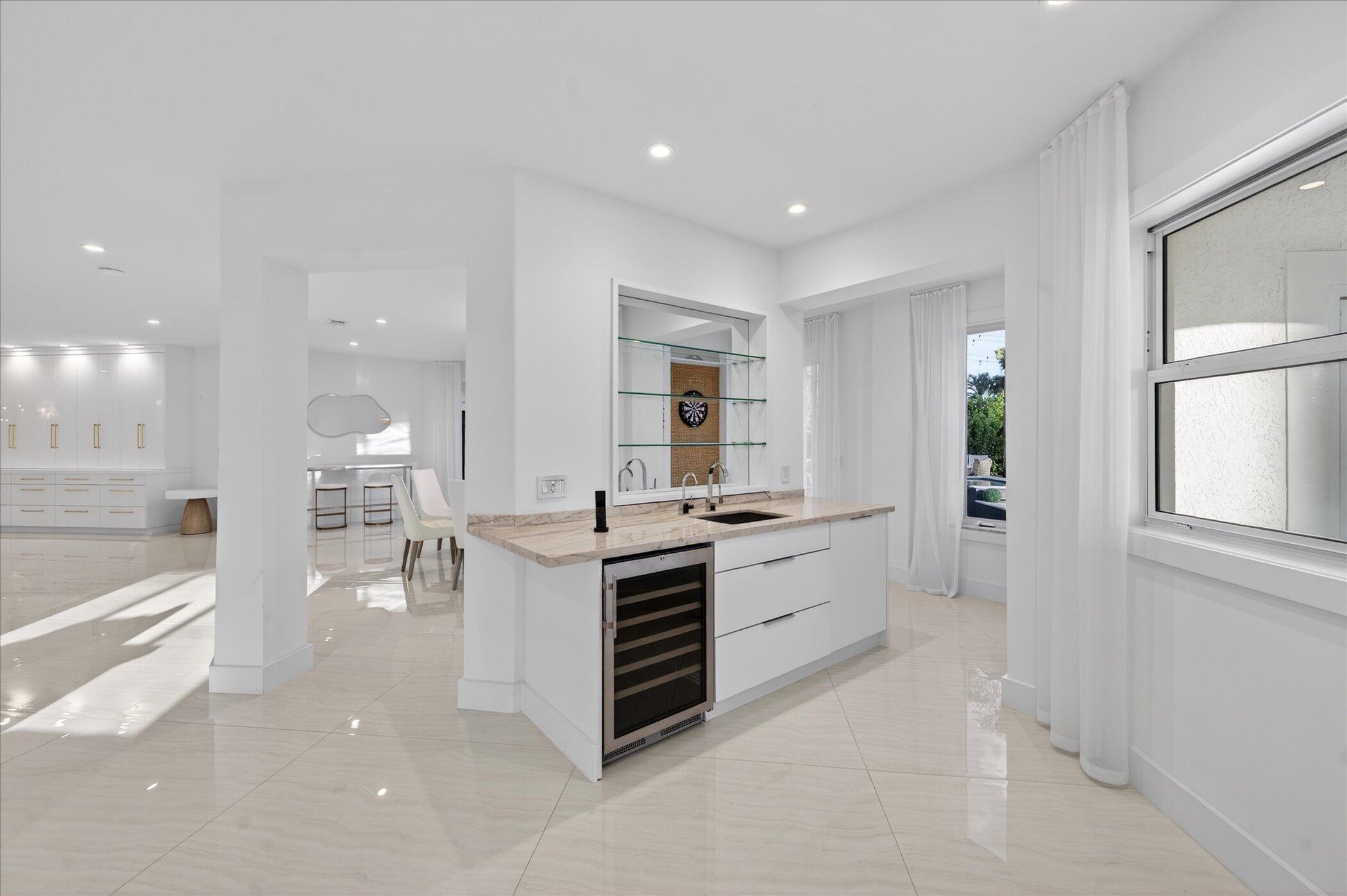 3872 Northwest 53rd Street Boca Raton, FL 33496 - Photo 18 of 43 a large white kitchen with a large window