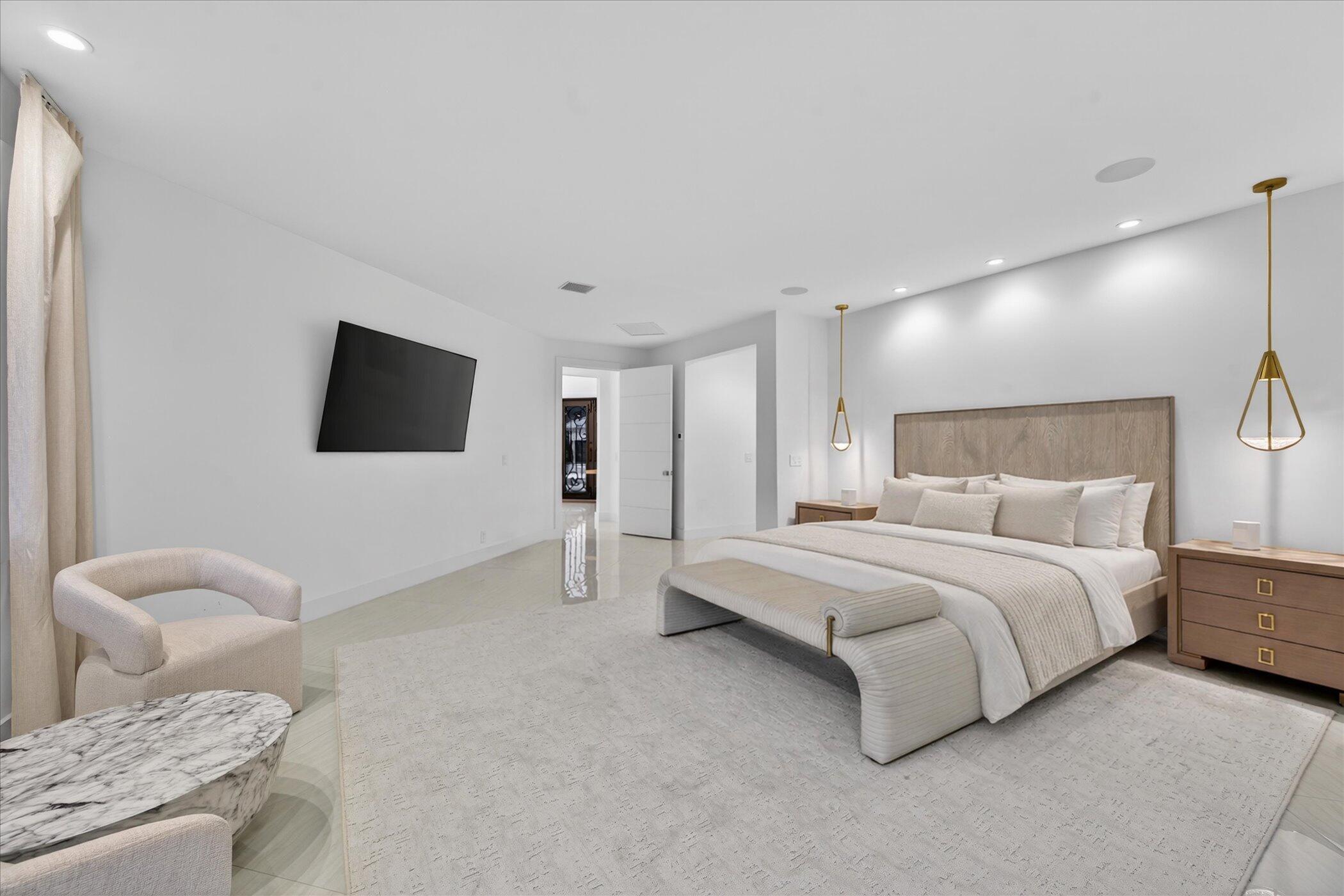 3872 Northwest 53rd Street Boca Raton, FL 33496 - Photo 19 of 43 a spacious bedroom with a bed and a flat screen tv