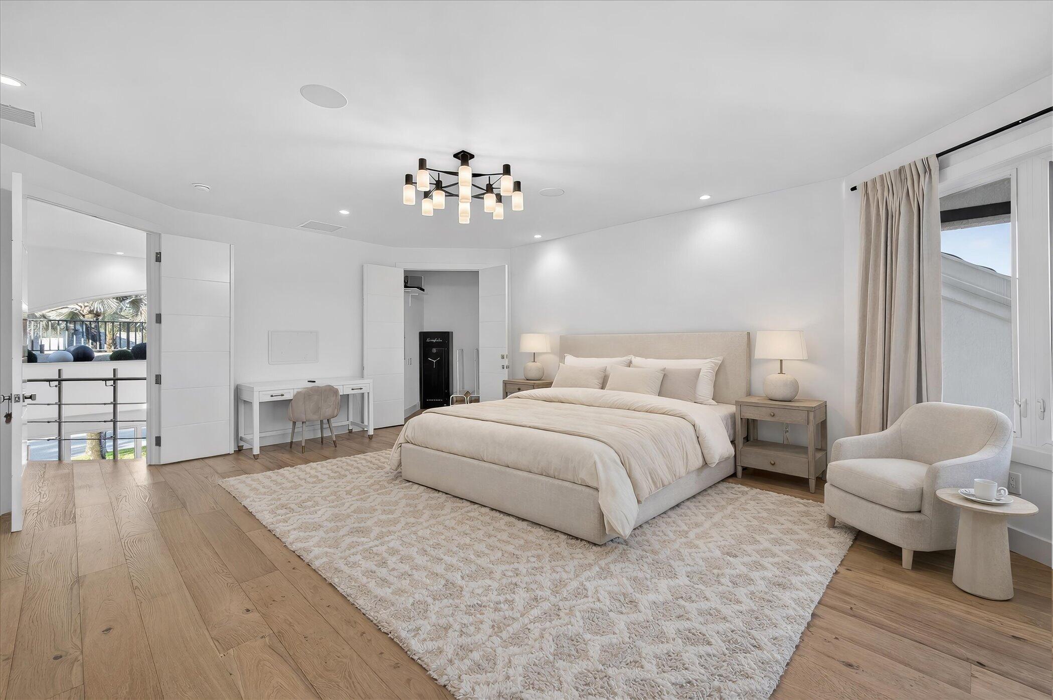 3872 Northwest 53rd Street Boca Raton, FL 33496 - Photo 24 of 43 a spacious bedroom with a bed and a chandelier