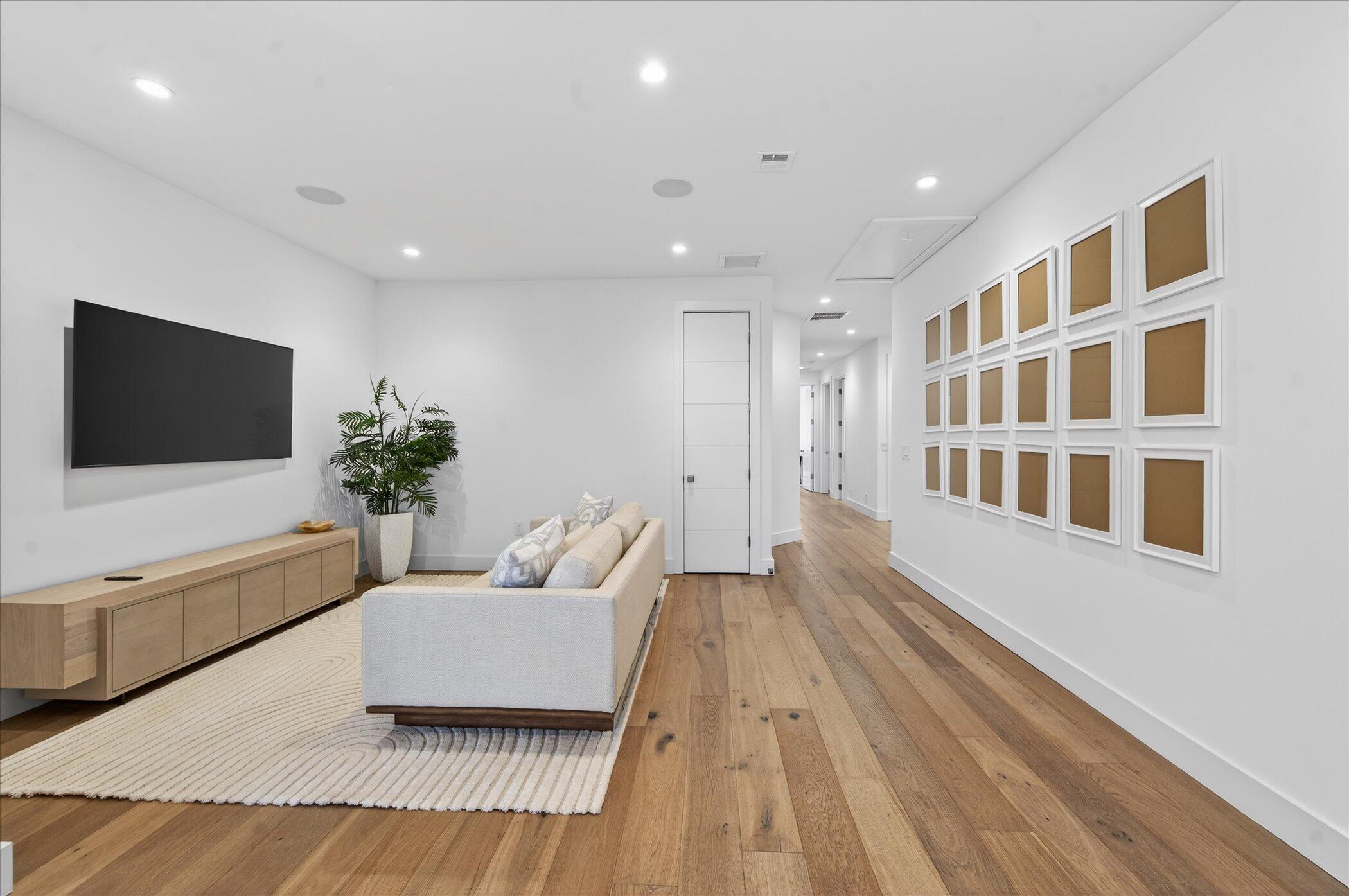 3872 Northwest 53rd Street Boca Raton, FL 33496 - Photo 25 of 43 a living room with furniture and a flat screen tv